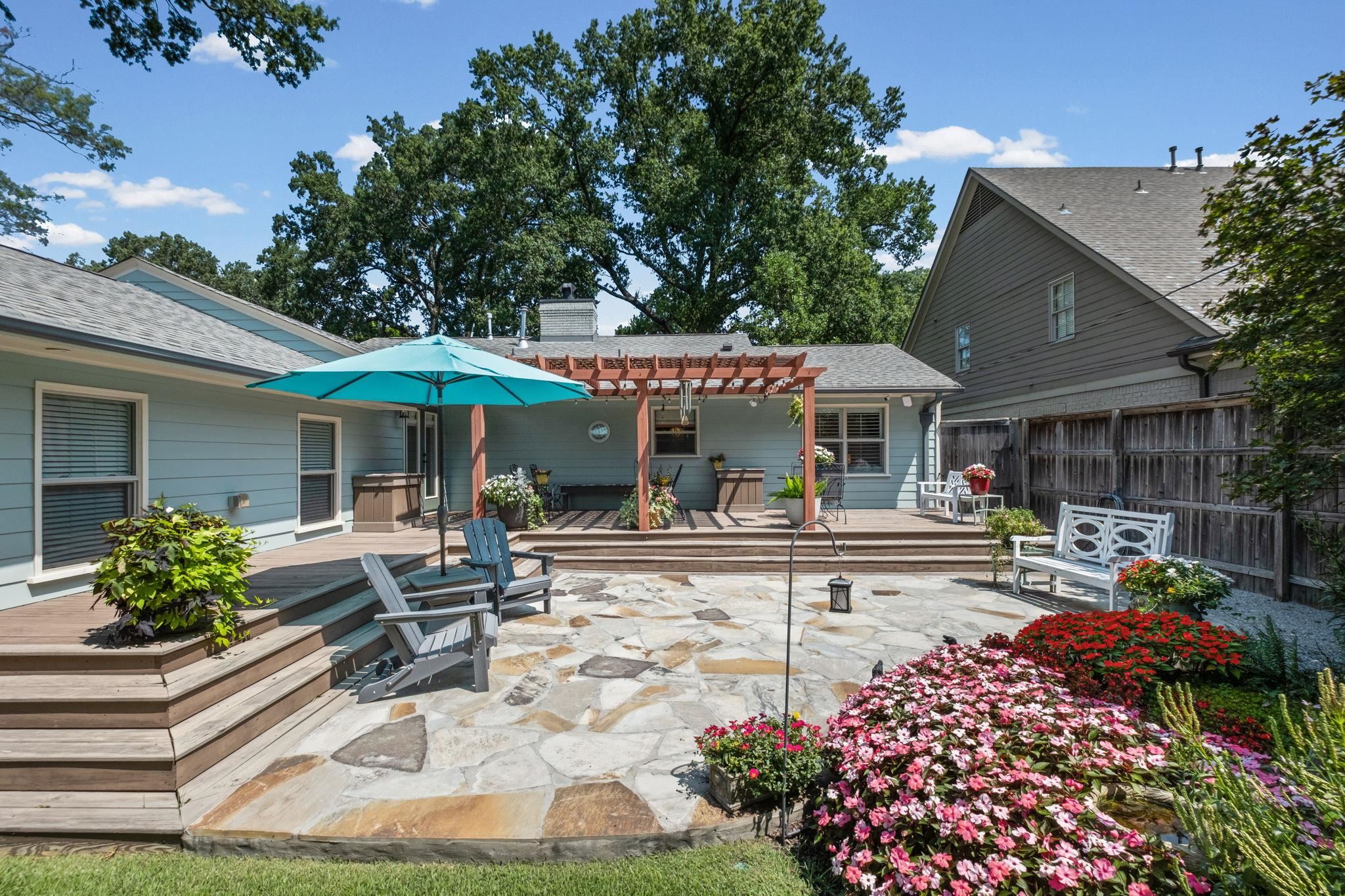 5079 Walnut Grove Road Memphis, TN 38117 - Photo 28 of 40 Expansive flagstone patio complemented by a multi-level wooden deck and a wooden pergola structure