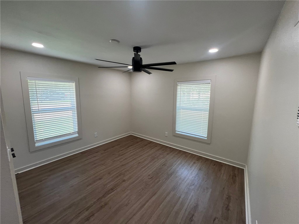 4501 College Main Street, Unit 1 Bryan, TX 77801 - Photo 7 of 8 a view of an empty room with a window and wooden floor