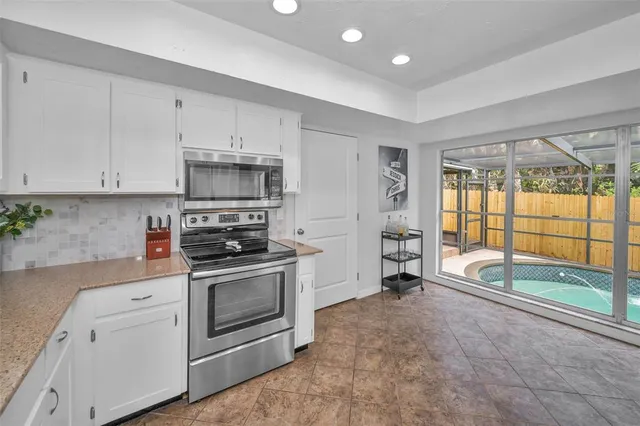 a bedroom with a bed and a flat tv screen on the dresser