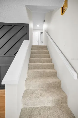 a front view of house with yard and trees in the background