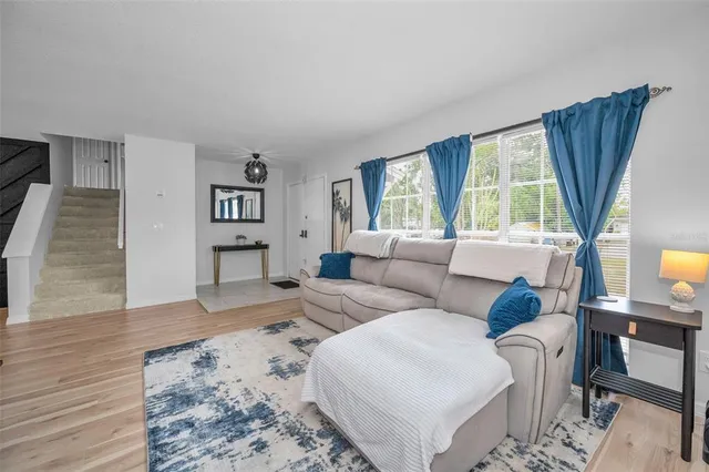 a kitchen with a refrigerator and white cabinets