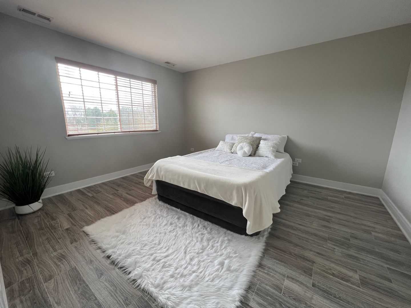 Undisclosed Address Lockport, IL 60441 - Photo 12 of 17 a spacious bedroom with a bed and wooden floor
