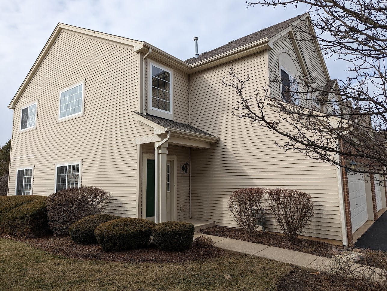 Undisclosed Address Lockport, IL 60441 - Photo 3 of 17 a view of a house with a large window and potted plants