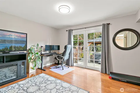 a view of a room with wooden floor and windows