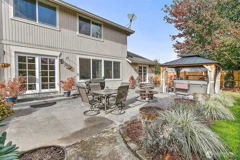 a view of a patio with table and chairs under an umbrella