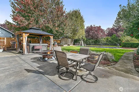 a view of a house with backyard and porch