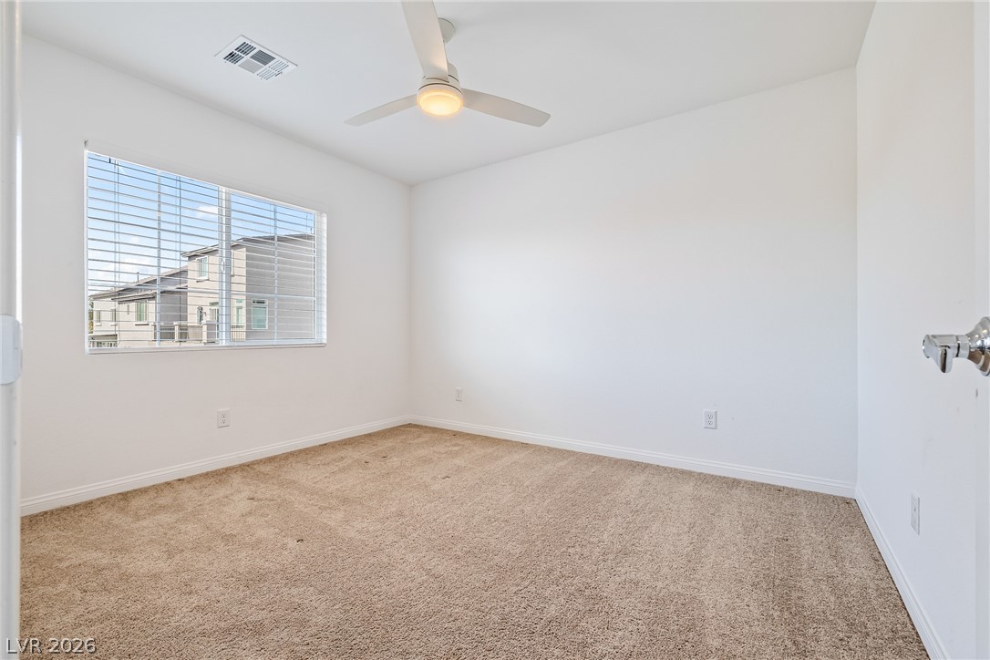5510 Ripple Ridge Avenue Las Vegas, NV 89139 - Photo 37 of 45 Bright and airy room with clean lines, featuring a large window overlooking the neighborhood.