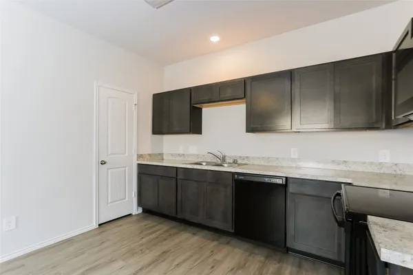 a kitchen with stainless steel appliances granite countertop a sink and cabinets