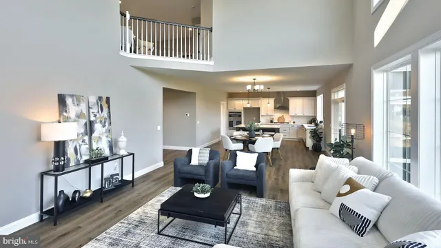 a living room with furniture couches and a dining table with wooden floor