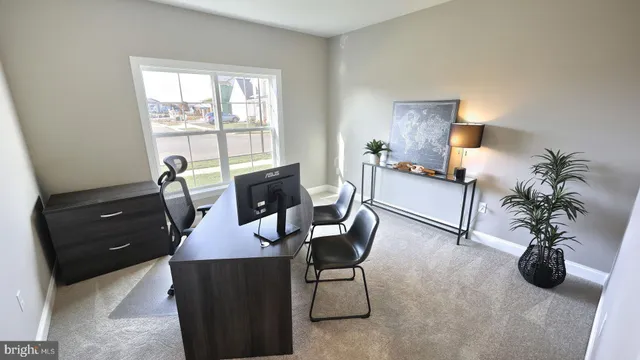 a view of a livingroom with furniture and a window