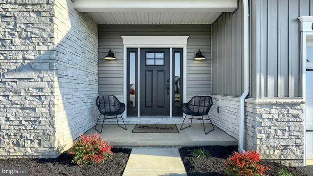 a front view of a house with outdoor seating