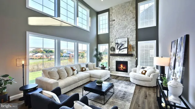 a living room with furniture fireplace and a large window
