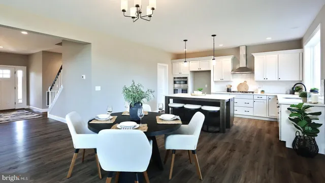a dining room with furniture and wooden floor