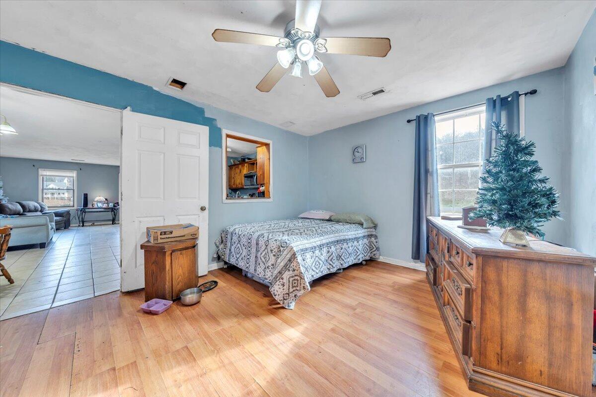 68 Old Sawmill Road Blue Ridge, VA 24064 - Photo 17 of 43 a bedroom with a bed and a chandelier