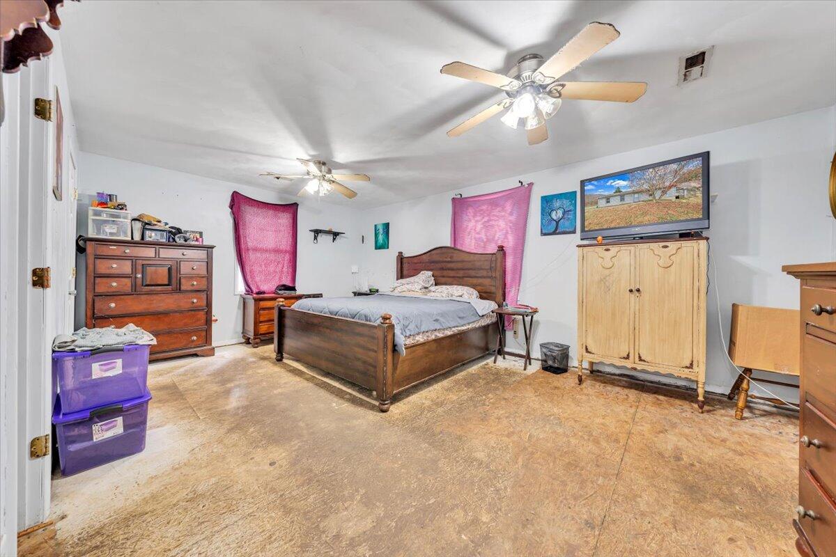 68 Old Sawmill Road Blue Ridge, VA 24064 - Photo 18 of 43 a spacious bedroom with a bed and a chandelier
