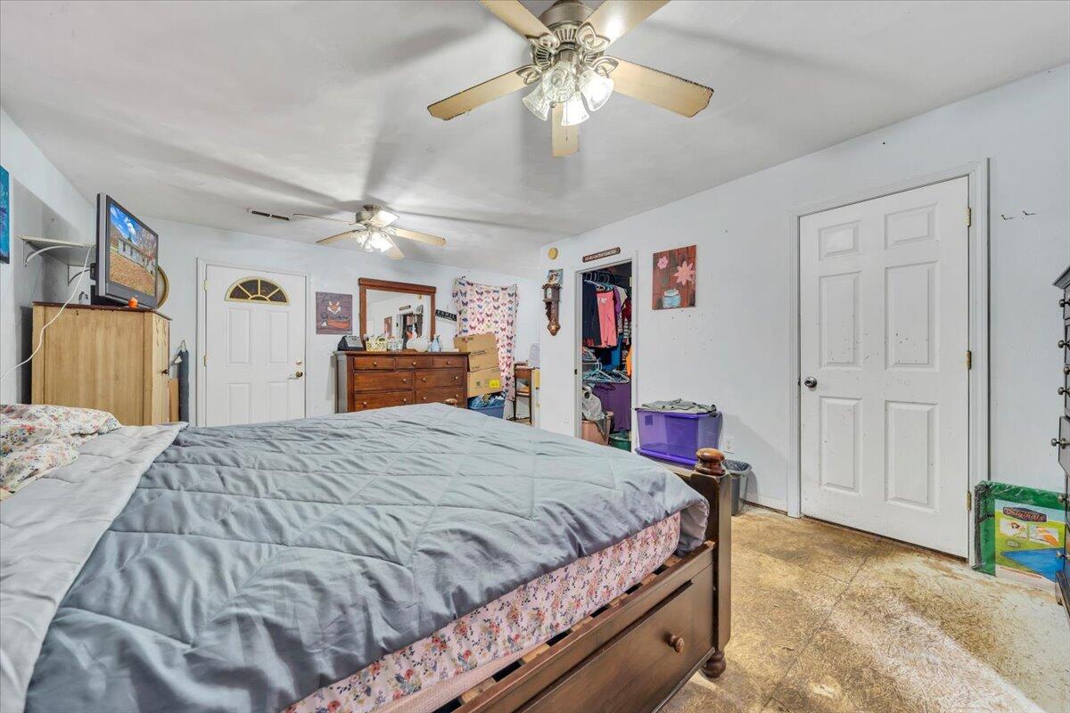 68 Old Sawmill Road Blue Ridge, VA 24064 - Photo 19 of 43 a bedroom with a bed and a chandelier