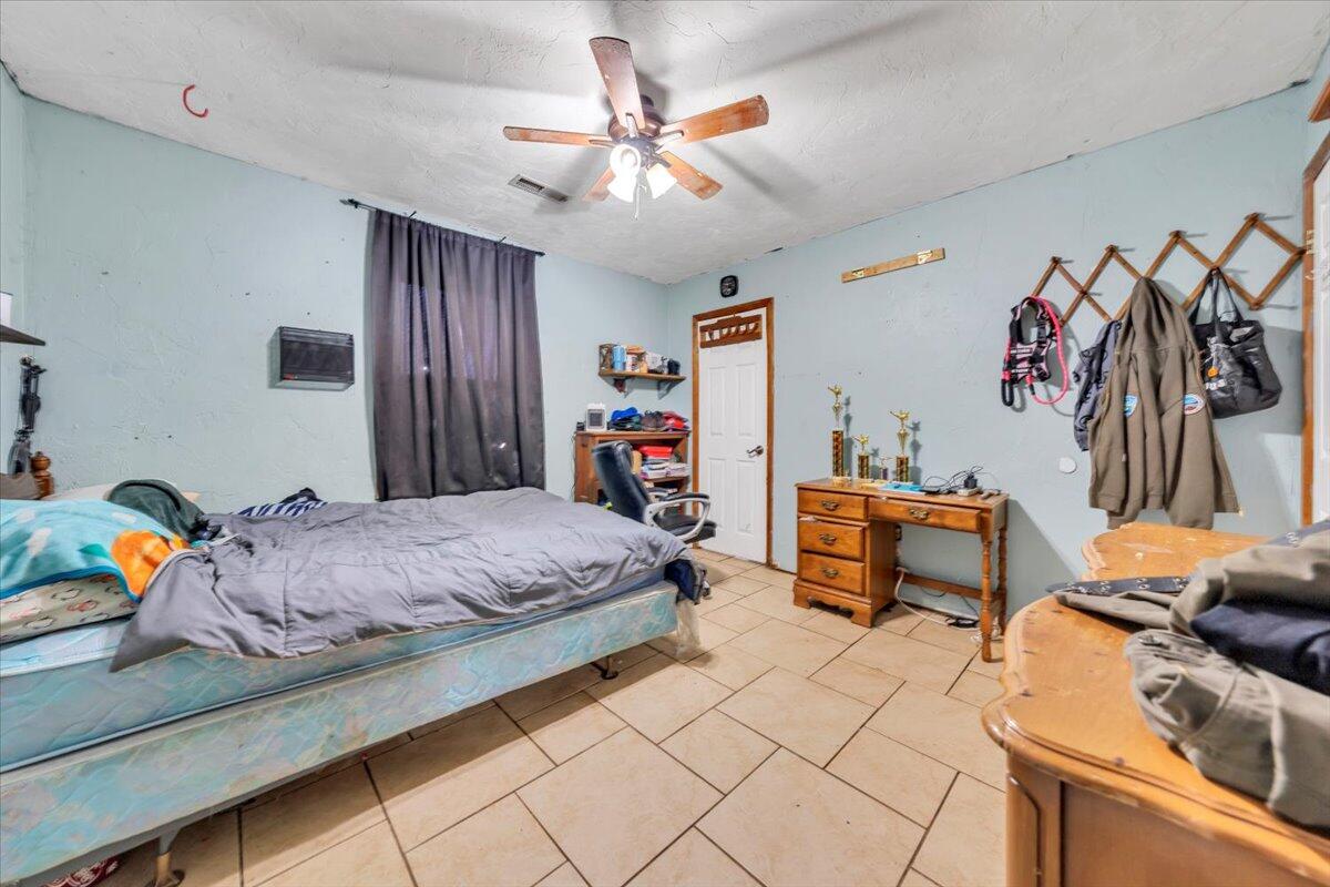 68 Old Sawmill Road Blue Ridge, VA 24064 - Photo 28 of 43 a bedroom with a bed and a chandelier