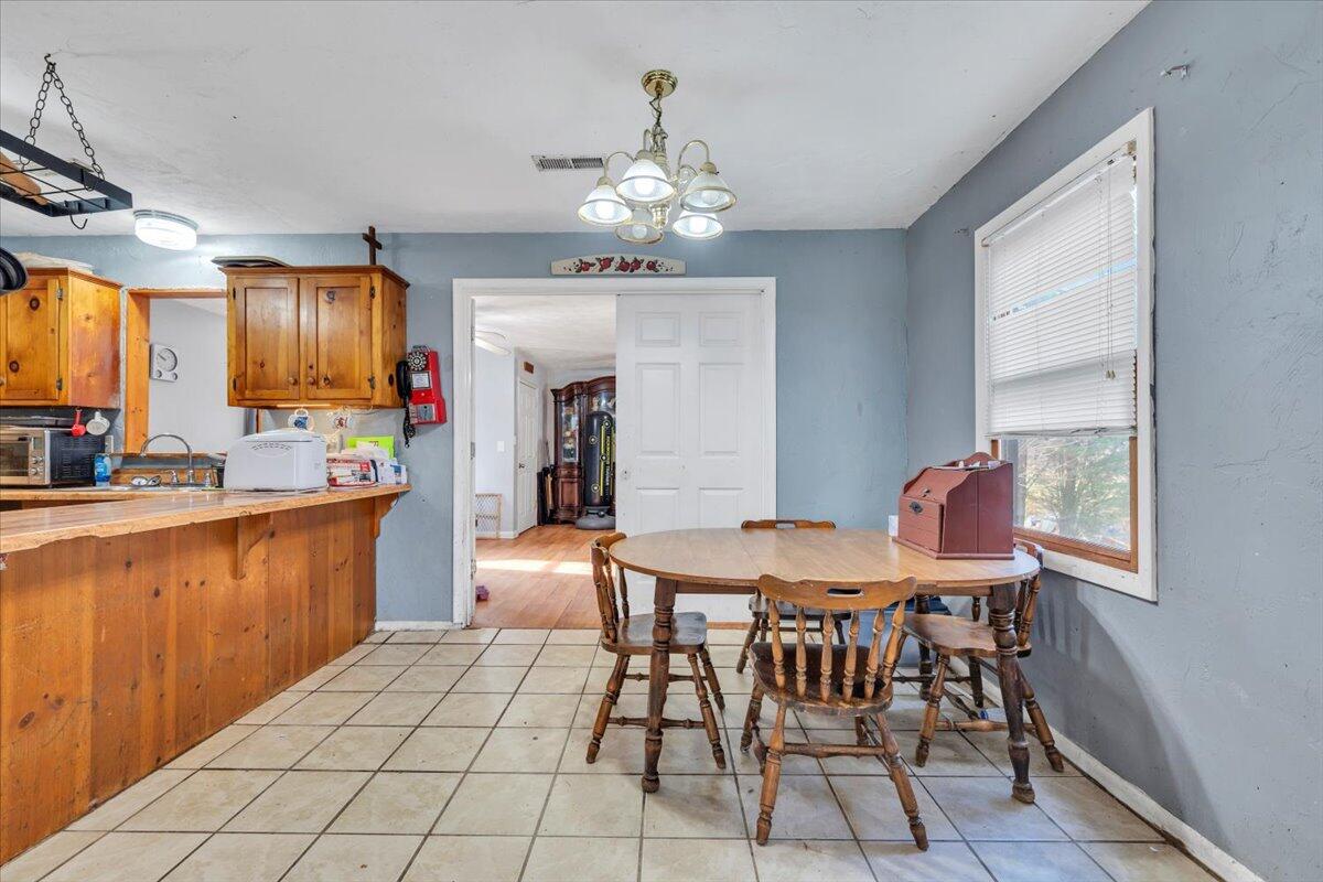 68 Old Sawmill Road Blue Ridge, VA 24064 - Photo 8 of 43 a view of a dining room with furniture and chandelier