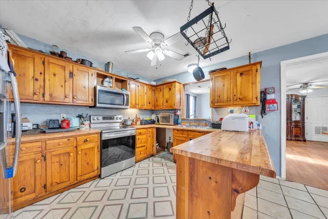 a kitchen with stainless steel appliances granite countertop a sink and cabinets