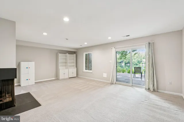 a view of an empty room with a fireplace