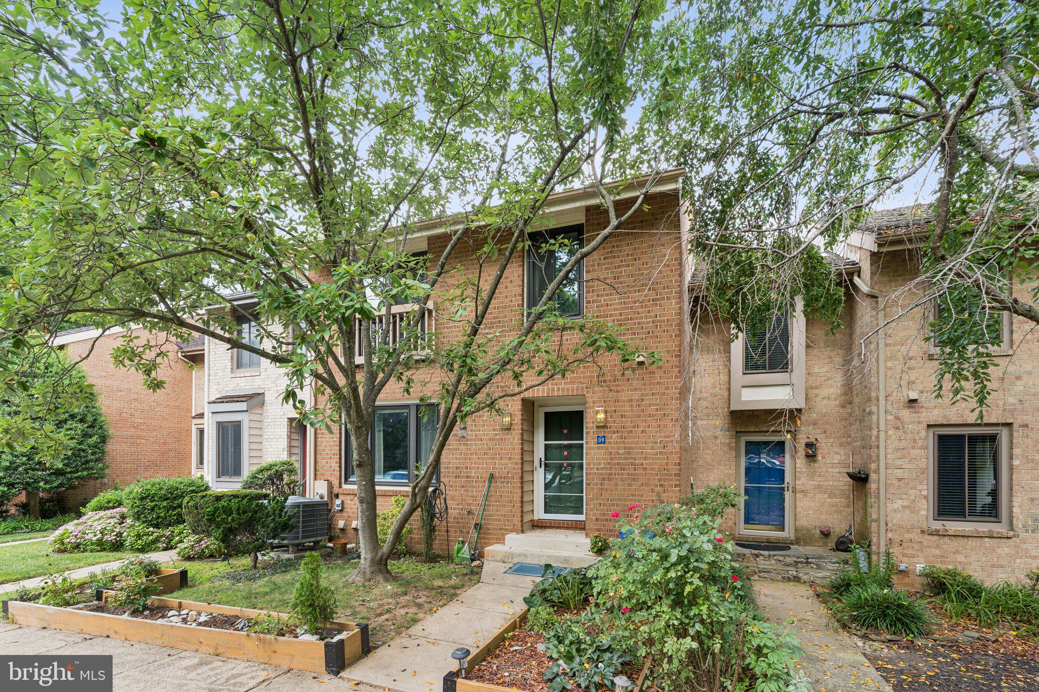 2009 Swans Neck Way Reston, VA 20191 - Photo 2 of 37 a front view of a house with garden