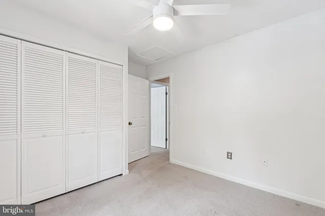 an empty room with windows and closet