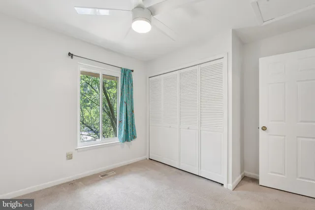 a utility room with cabinets and washer dryer