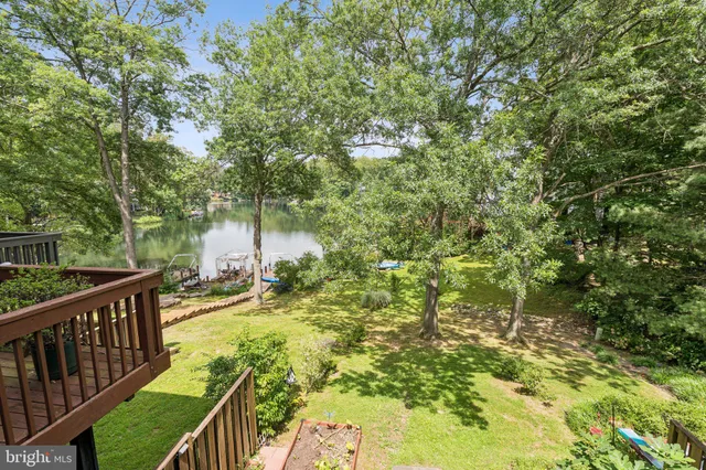 a view of backyard with deck and outdoor seating
