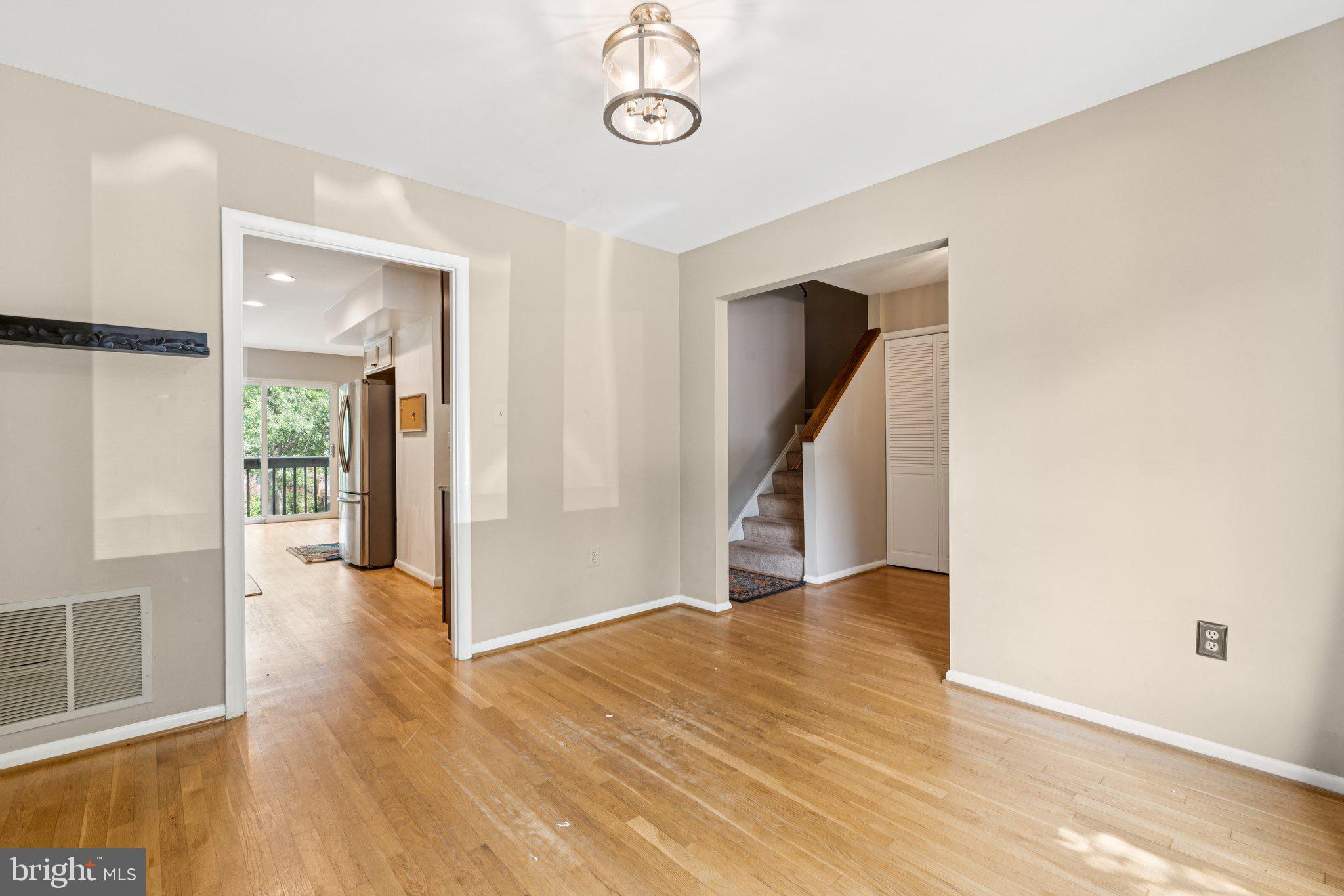 2009 Swans Neck Way Reston, VA 20191 - Photo 4 of 37 a view of an empty room with wooden floor and a window
