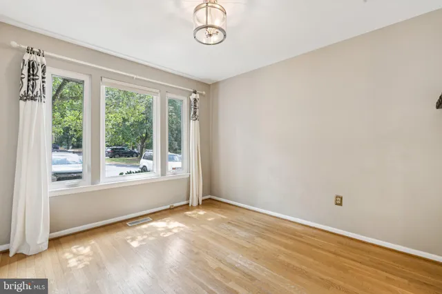 a view of a livingroom with wooden floor and window
