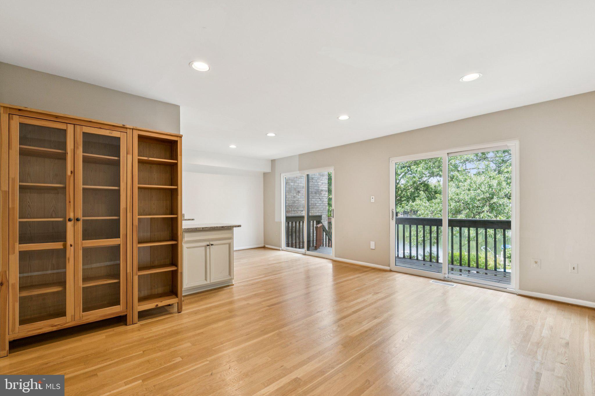 2009 Swans Neck Way Reston, VA 20191 - Photo 6 of 37 a view of an empty room with wooden floor and a window