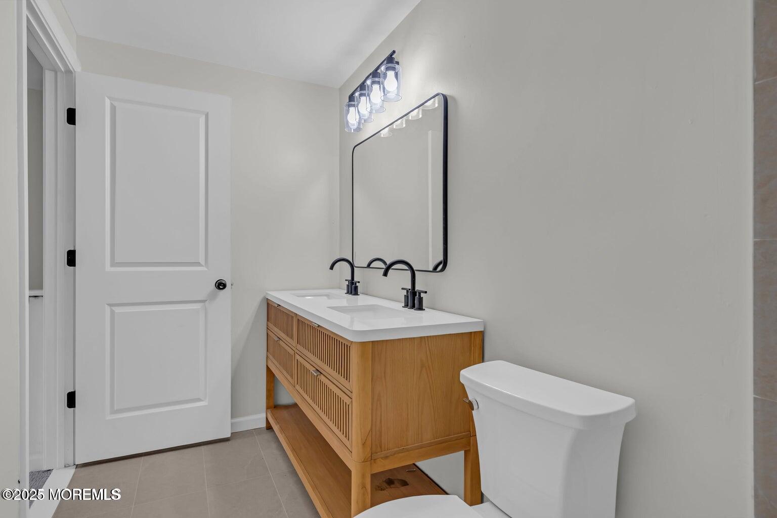 58 Garden Avenue Island Heights, NJ 08732 - Photo 11 of 46 a bathroom with a toilet sink and mirror