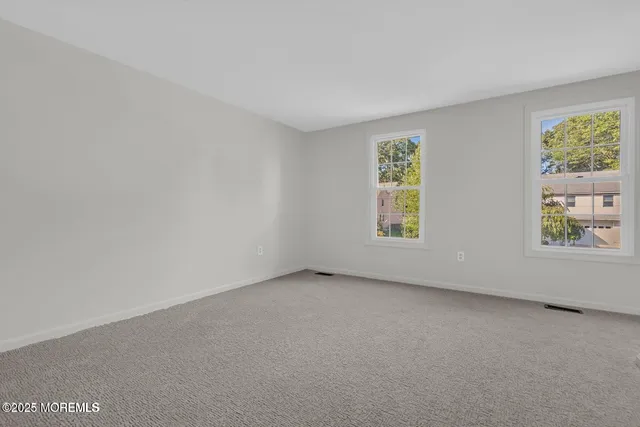 a view of an empty room and closet area