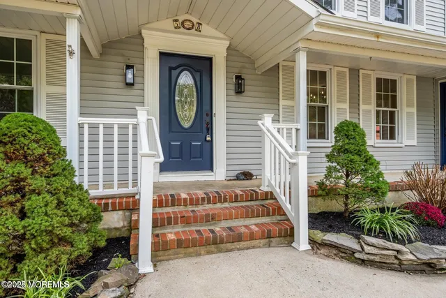 a front view of a house with plants