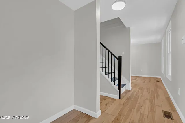 a view of a kitchen with wooden floor and electronic appliances