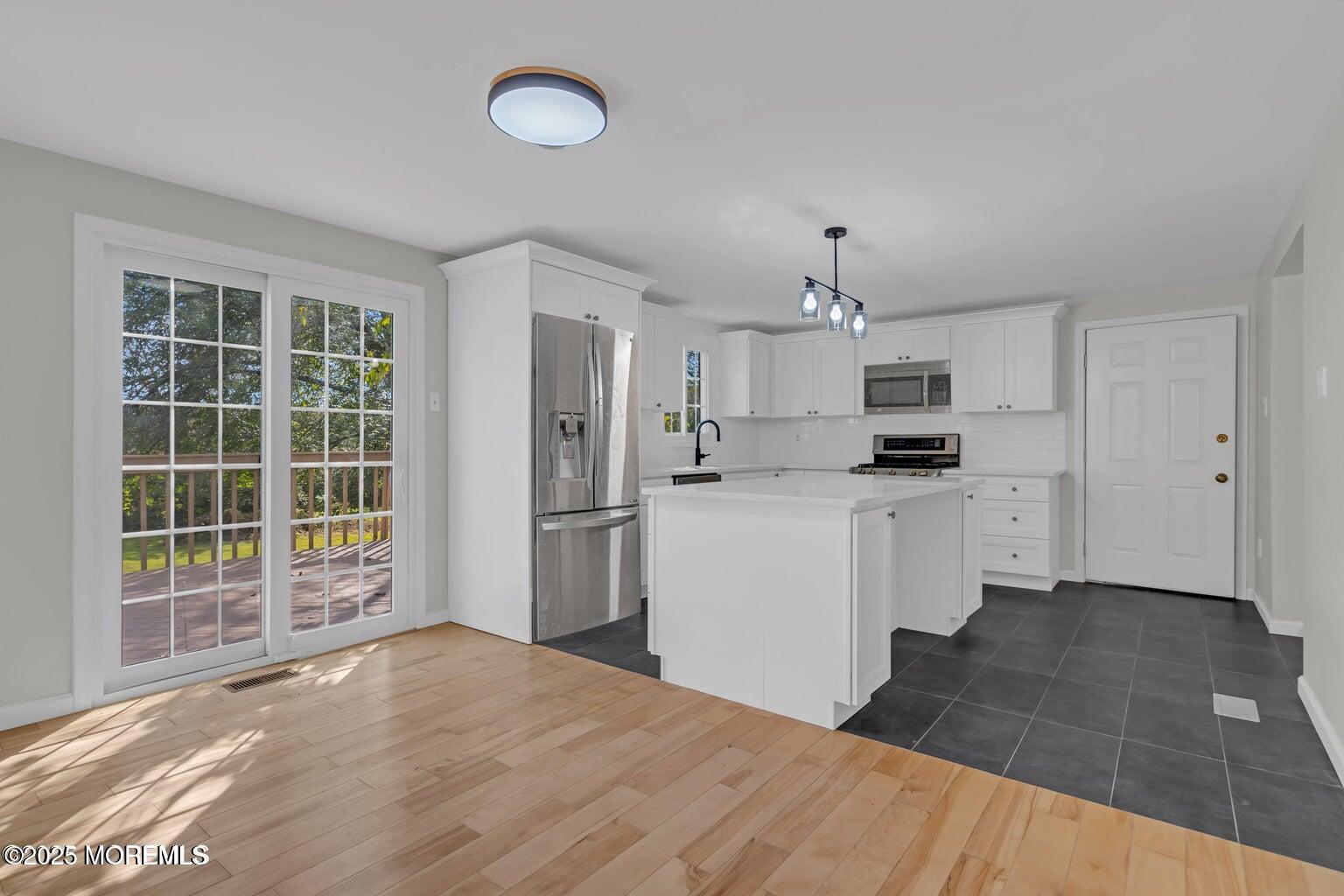 58 Garden Avenue Island Heights, NJ 08732 - Photo 34 of 46 a view of a kitchen with wooden floor and electronic appliances