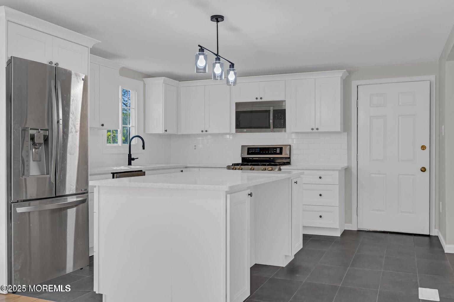 58 Garden Avenue Island Heights, NJ 08732 - Photo 35 of 46 a kitchen with stainless steel appliances a refrigerator sink and microwave