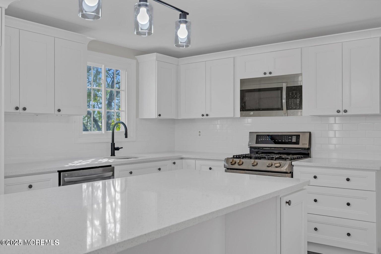 58 Garden Avenue Island Heights, NJ 08732 - Photo 4 of 46 a kitchen with appliances a sink and a stove