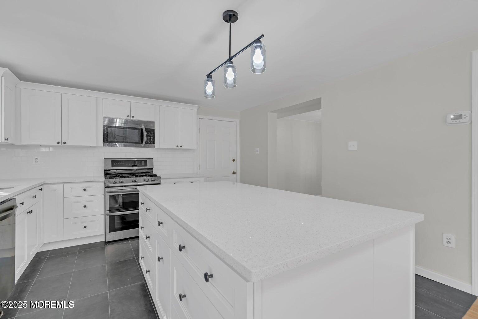 58 Garden Avenue Island Heights, NJ 08732 - Photo 5 of 46 a kitchen with cabinets appliances and a ceiling fan