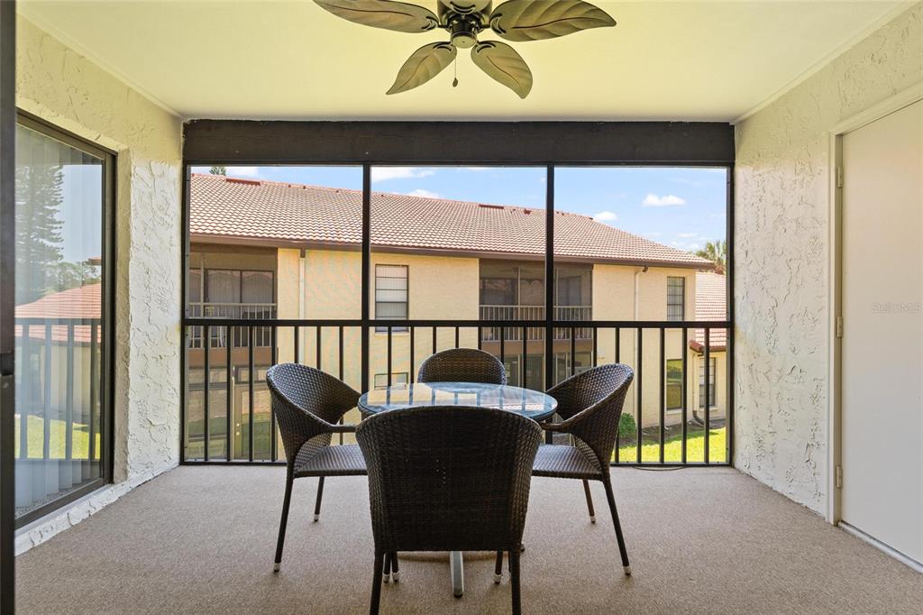 1801 East Lake Road South, Unit 4E Palm Harbor, FL 34685 - Photo 23 of 26 a view of a chairs and table in the room