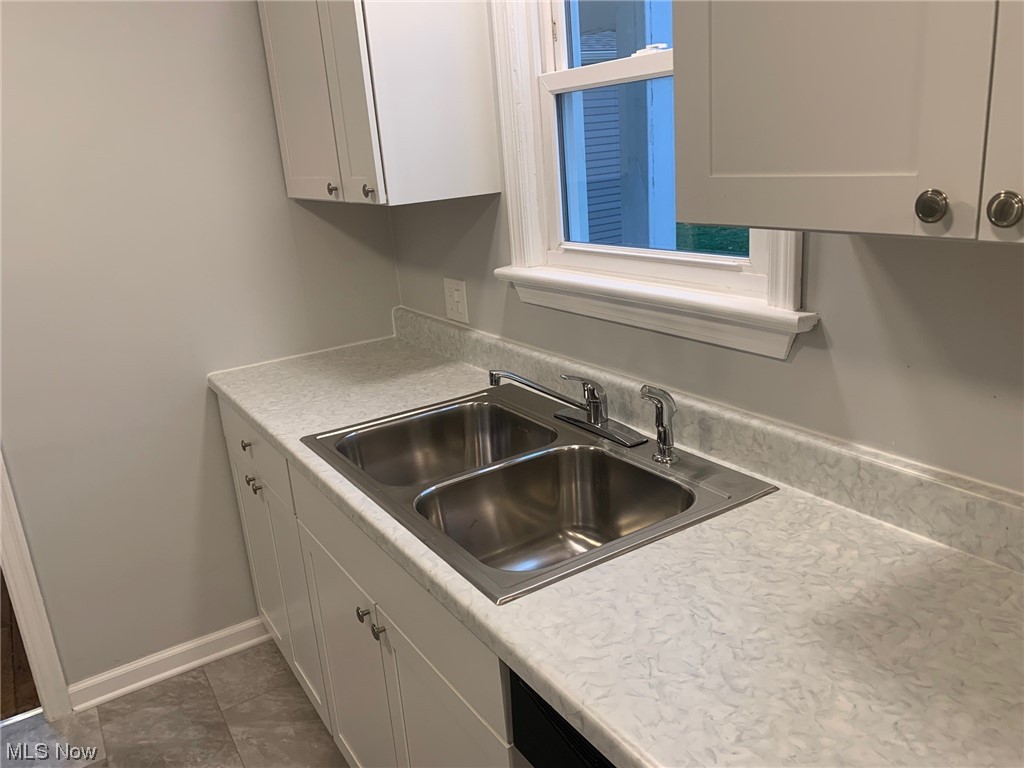1456 Evanston Road Lyndhurst, OH 44124 - Photo 8 of 32 Kitchen with dark tile flooring, white cabinets, and sink