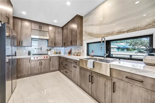 a dining room with furniture a chandelier and wooden floor