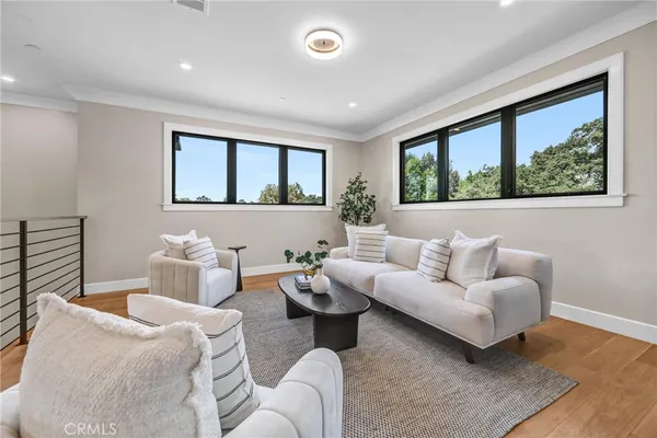 a bedroom with furniture and a large window