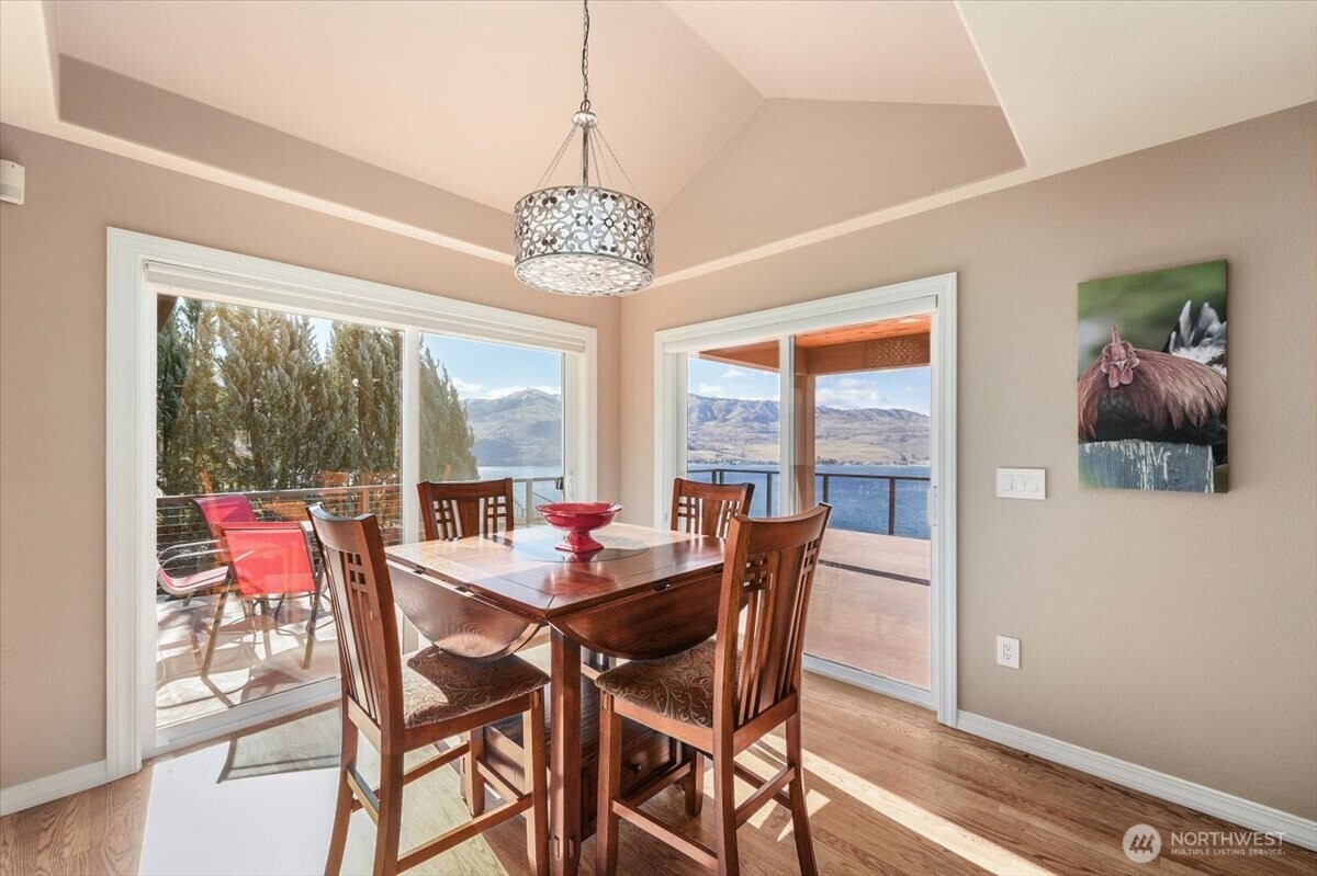 333 Highpoint Place Chelan, WA 98816 - Photo 15 of 40 a view of a dining room with furniture wooden floor and chandelier