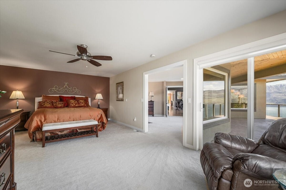 333 Highpoint Place Chelan, WA 98816 - Photo 18 of 40 a bedroom with a bed and glass door