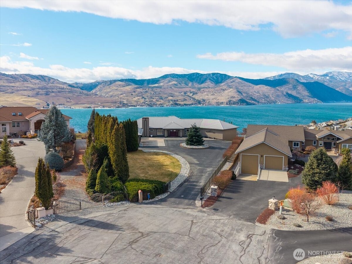 333 Highpoint Place Chelan, WA 98816 - Photo 2 of 40 an aerial view of a house with swimming pool and mountain view
