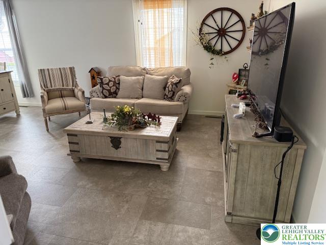 7468 Continental Circle Trexlertown, PA 18087 - Photo 3 of 13 a living room with furniture a window and a flat screen tv