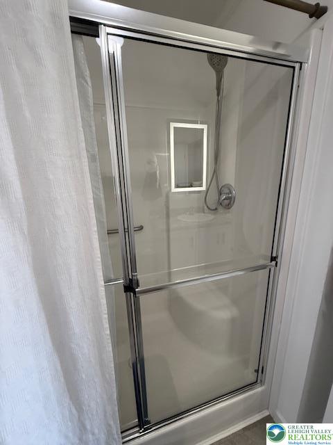 7468 Continental Circle Trexlertown, PA 18087 - Photo 9 of 13 a bathroom with a glass shower door