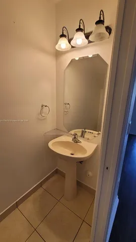 a bathroom with a sink and mirror