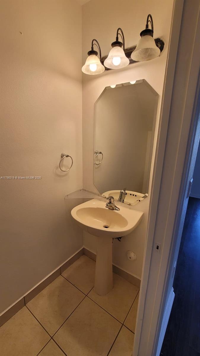 8353 Southwest 26 Th Street, Unit 104 Miramar, FL 33025 - Photo 11 of 14 a bathroom with a sink and mirror